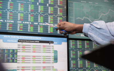 Close up shot of brokerage company employee indicating on display real time profit growth and market trend.